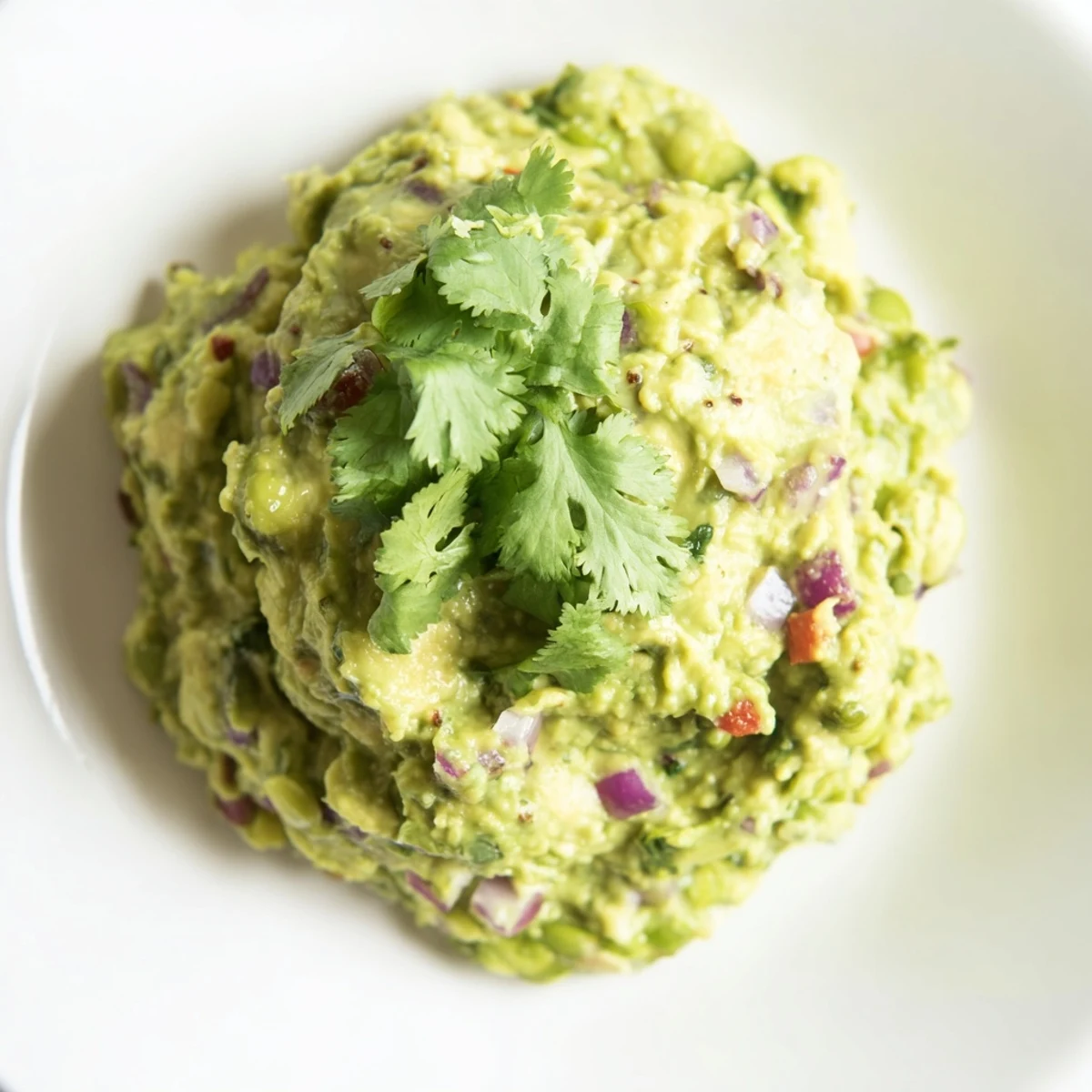 Delicious, healthy edamame guacamole with avocado, and fresh lime, perfect for a gathering.