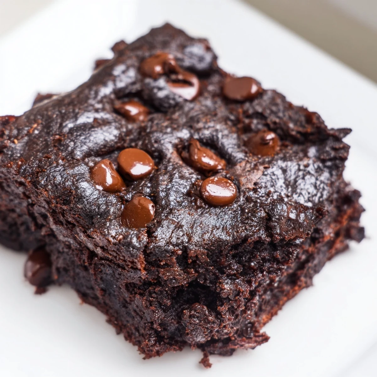 A close-up shot of baked Greek yogurt brownies, offering a delightful, chocolatey dessert.