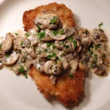 A close-up of crispy Jaeger Schnitzel with savory mushroom gravy, perfect for any dinner.