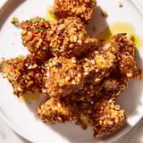 Close-up image of pretzel crusted chicken bites, showing the crunchy, golden-brown pretzel coating.