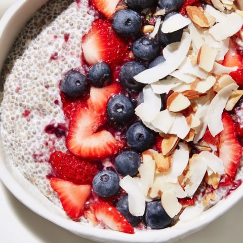 Creamy berry chia pudding layers with vibrant mixed berries, a delicious make-ahead breakfast.