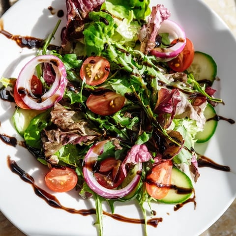 A light and flavorful Quick Balsamic Vinegar Salad, tossed and ready to serve on a plate.