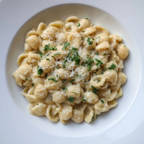 Creamy ditalini pasta with garlic, garnished with fresh parsley, ready to serve and enjoy.