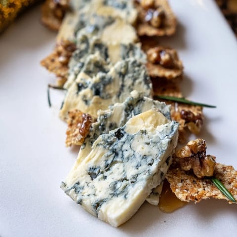 Elegant Blue Ridge Mountains cheese platter image: showcasing blue cheeses, crackers, and honey drizzled.