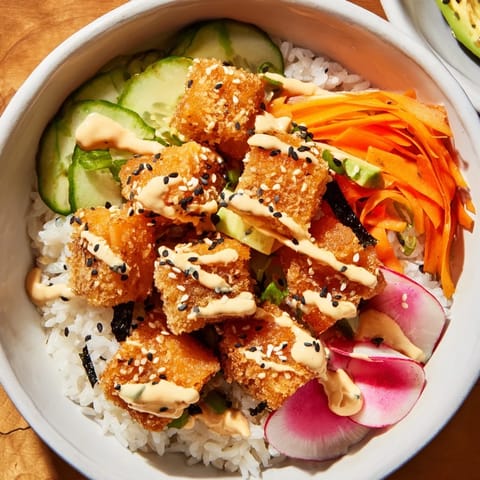 Close-up of a Salmon Bites Bowl: perfectly cooked salmon with creamy sauce and colorful toppings.