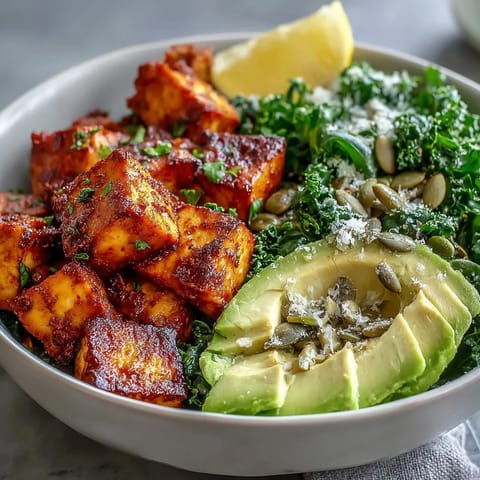 Crispy turmeric tofu, sautéed kale and creamy avocado in a vibrant breakfast bowl topped with pumpkin seeds.