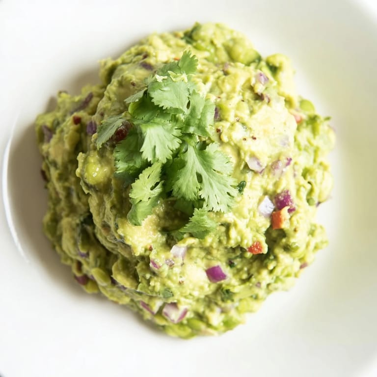 Delicious, healthy edamame guacamole with avocado, and fresh lime, perfect for a gathering.