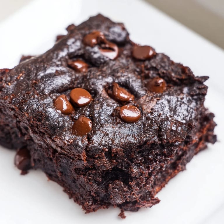 A close-up shot of baked Greek yogurt brownies, offering a delightful, chocolatey dessert.