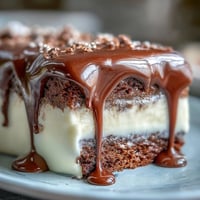 Graduation Cake mit weißer Schokoladenglasur und goldenen Ballons, ein beeindruckendes Festtagsdessert mit zarter Vanille-Buttercreme und dekorativen essbaren Goldakzenten.